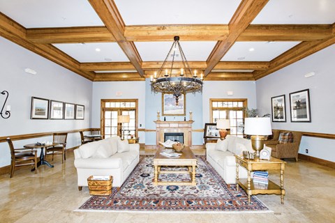 a living room with white couches and a fireplace